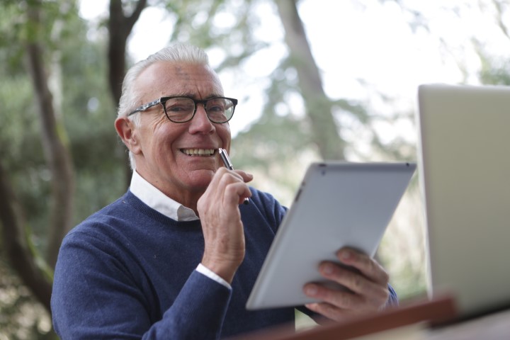 Old man using his tablet